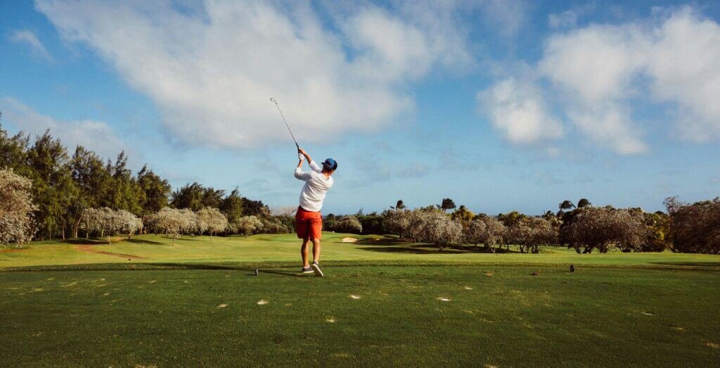 Man following through after hitting a golf ball